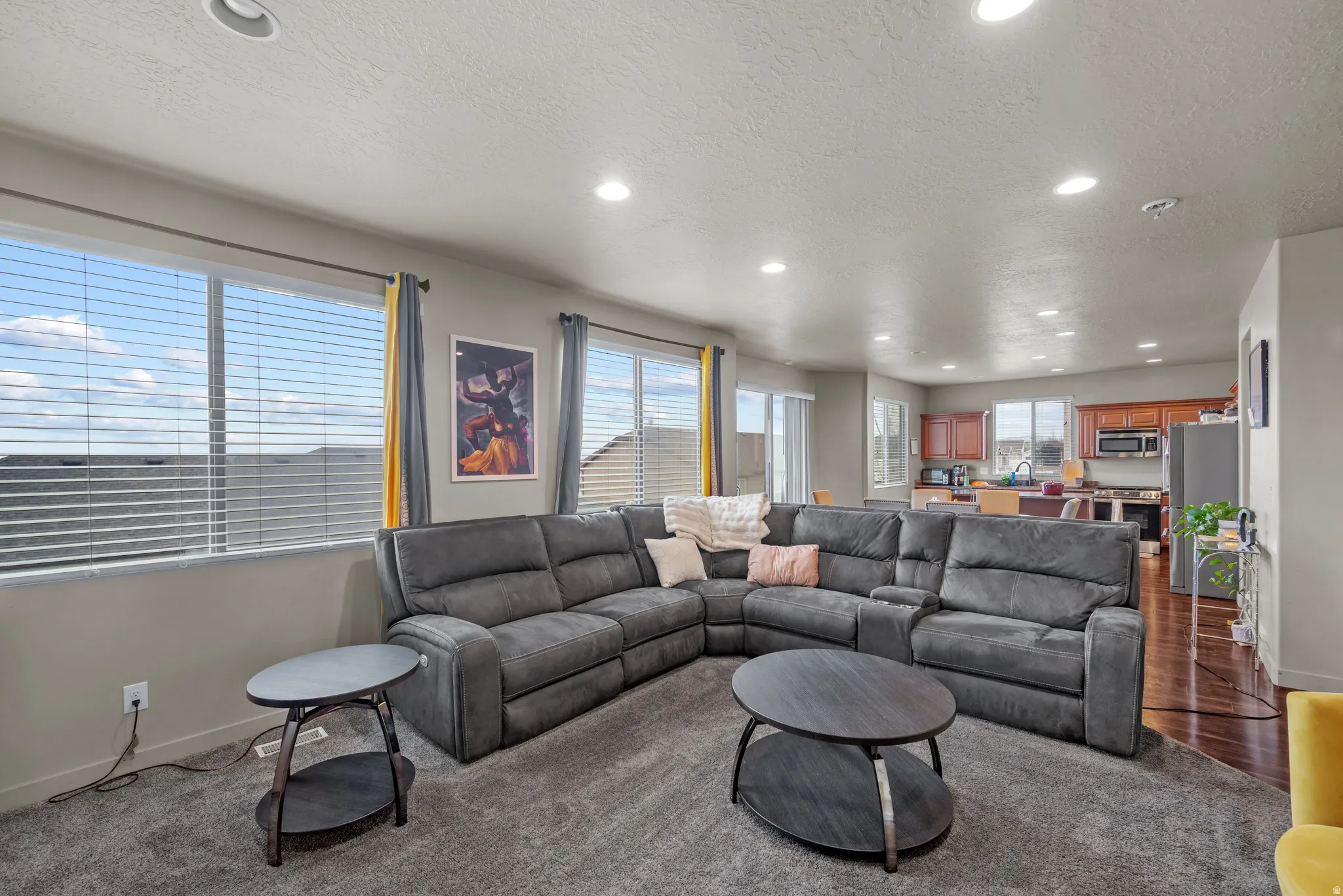 Living room featuring recessed lighting and a textured ceiling
