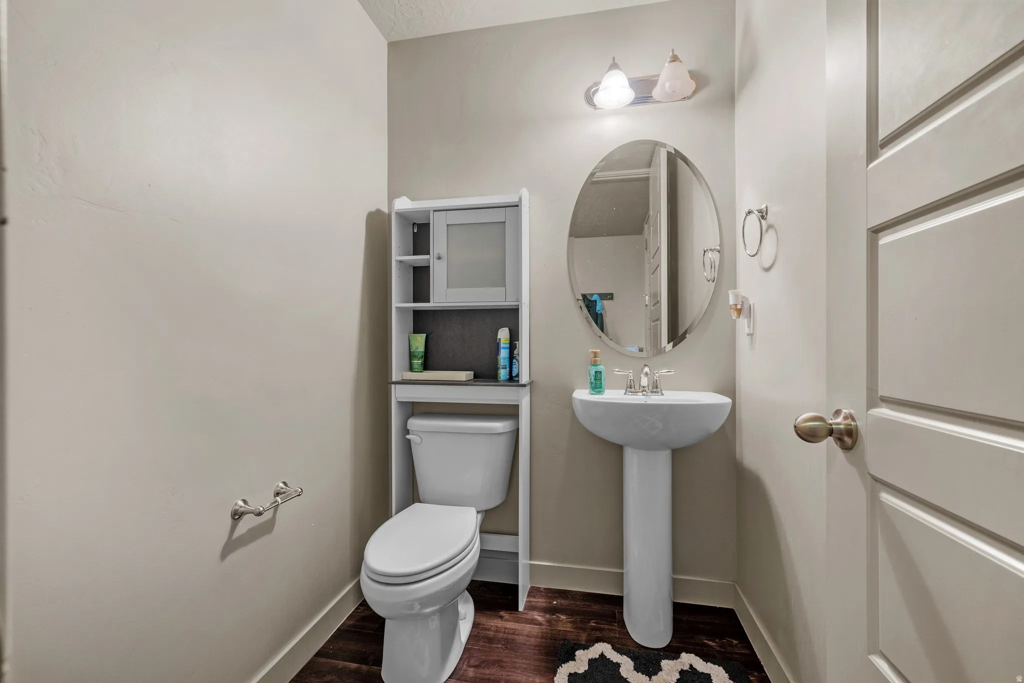 Bathroom featuring toilet and dark wood-style floors