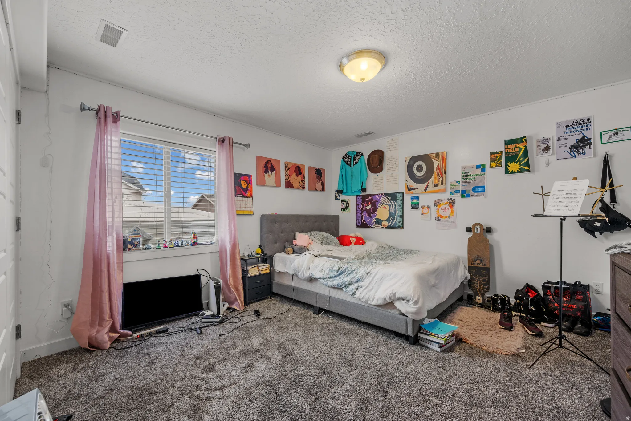 Carpeted bedroom featuring a textured ceiling