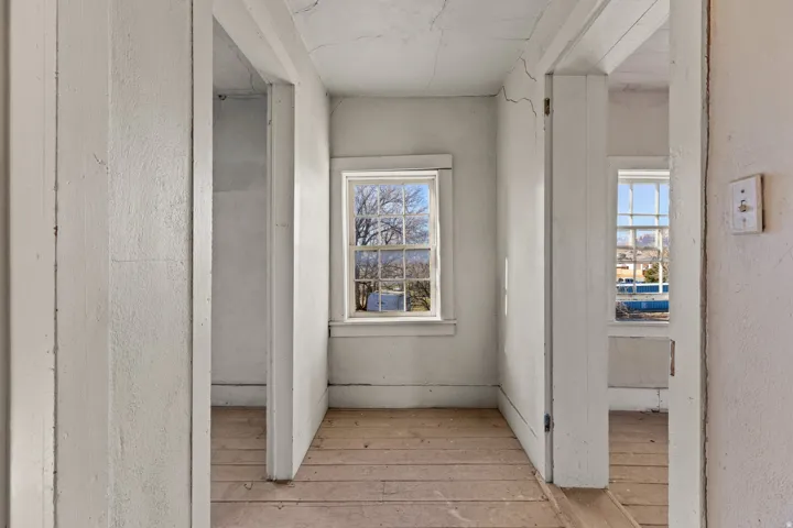 Corridor featuring light wood finished floors