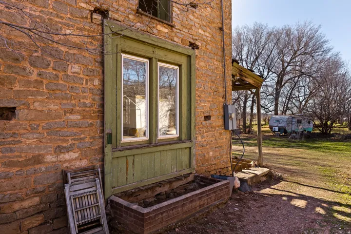 Entrance to property with stone siding