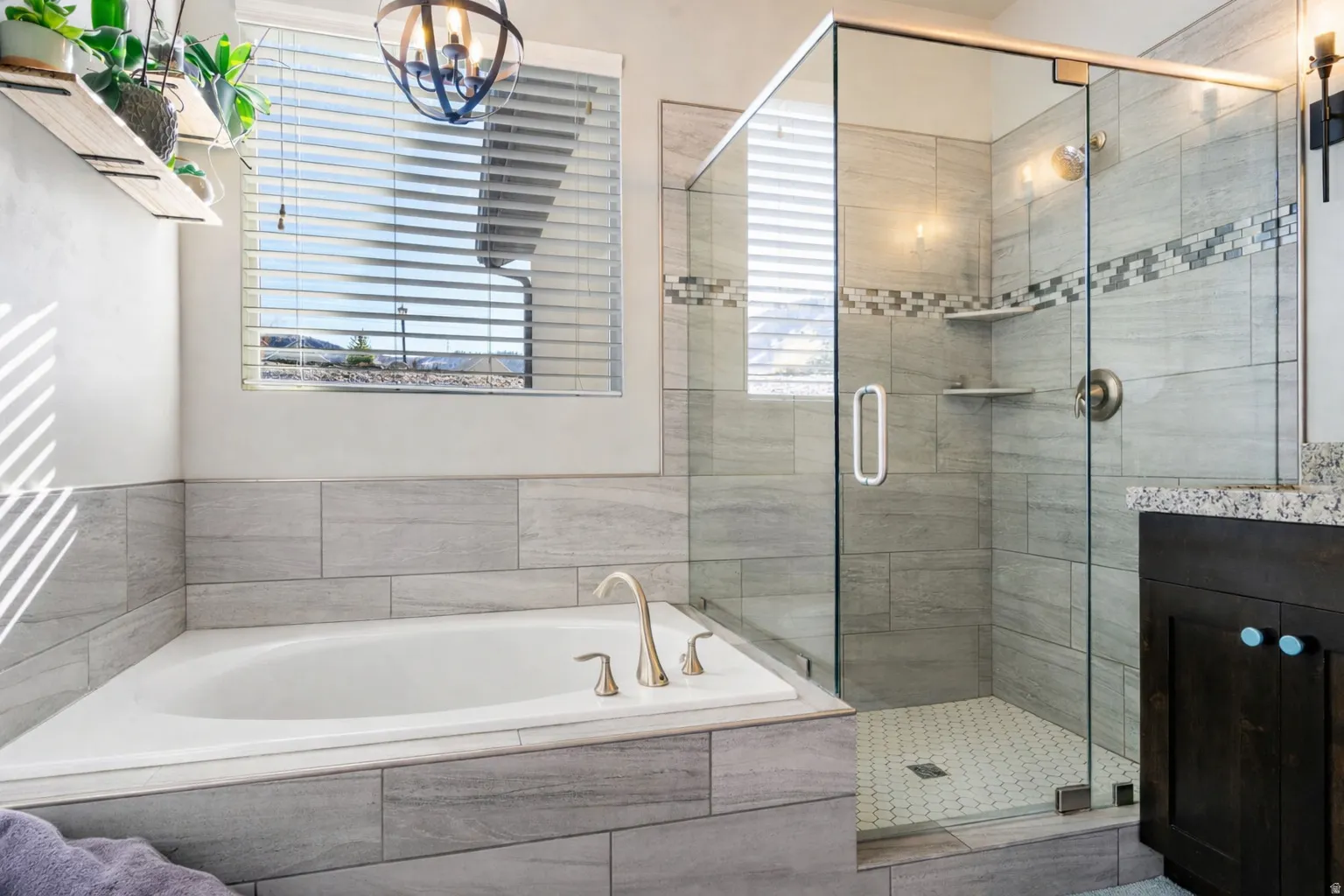 Full bathroom featuring vanity, a garden tub, and a stall shower