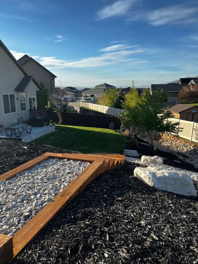 Fenced backyard with a patio, a residential view, and a wooden deck