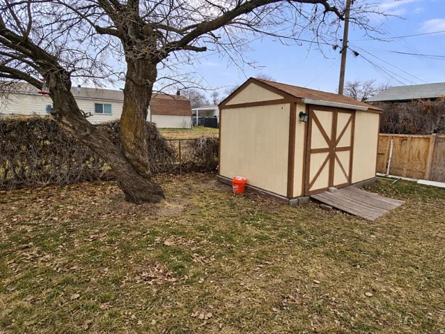 View of shed with a fenced backyard