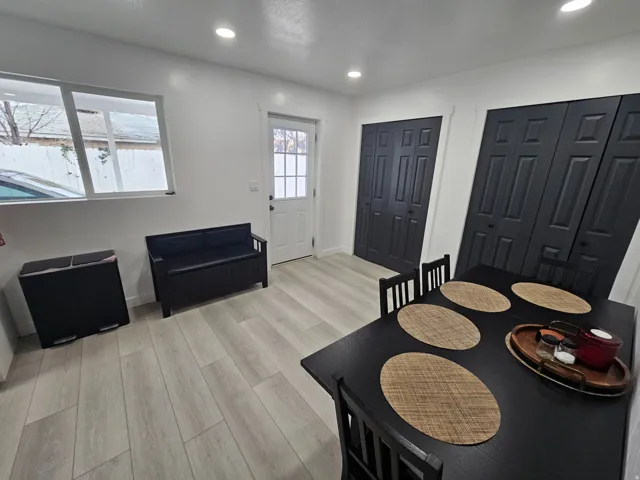 Dining space with light wood-type flooring and recessed lighting
