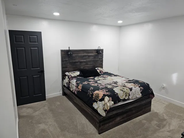 Bedroom featuring carpet flooring, recessed lighting, and a textured ceiling