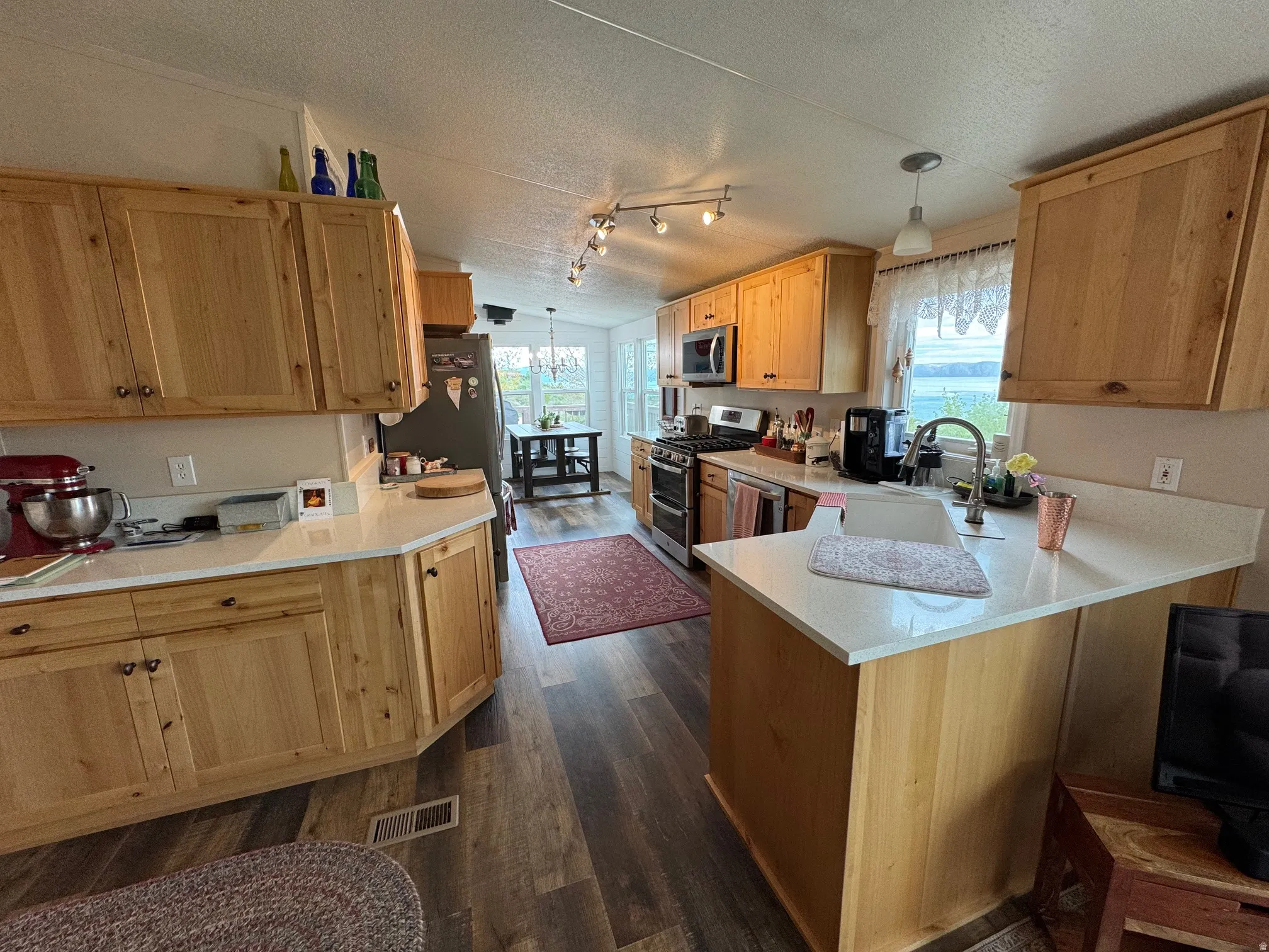 Kitchen featuring LVT flooring, appliances with stainless steel finishes, Quartz countertop, new cabinets
