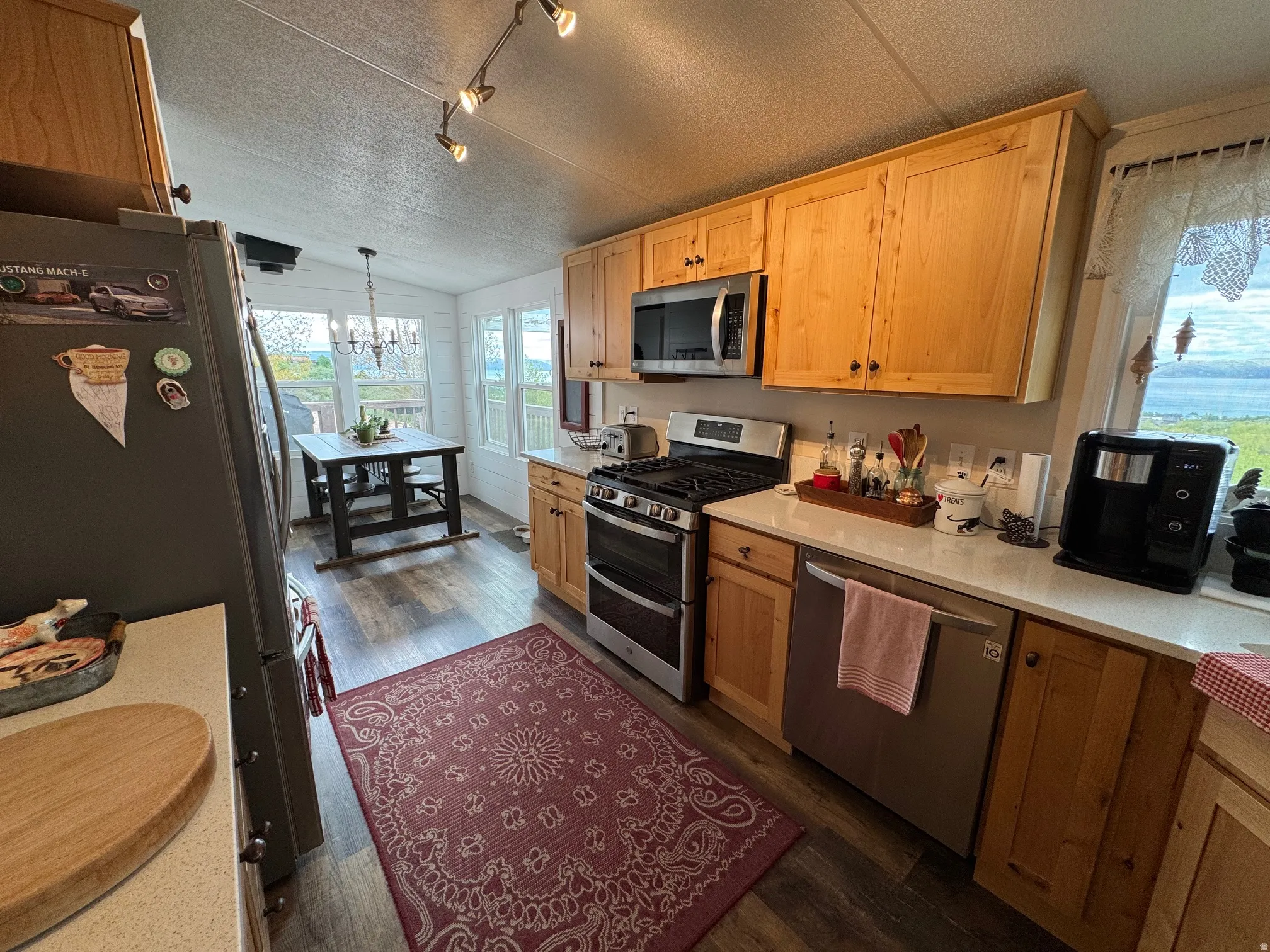 Kitchen featuring LVT flooring, appliances with stainless steel finishes