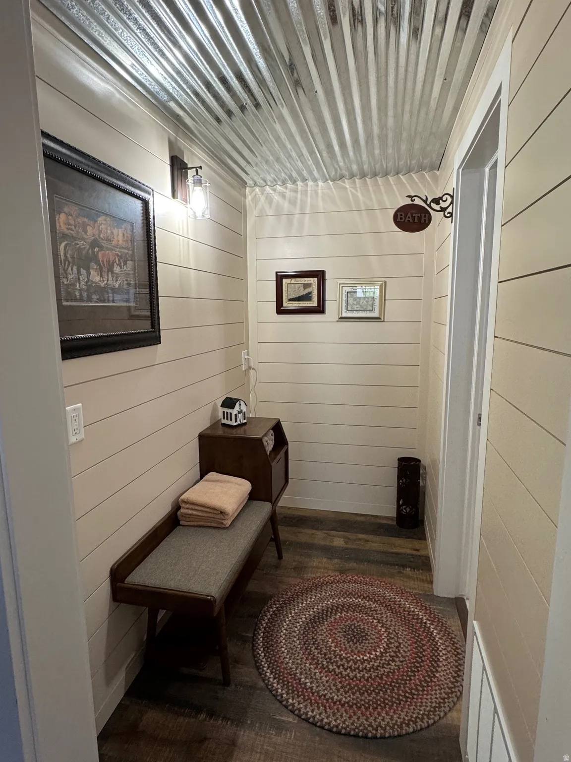 Corridor with wooden walls and dark wood finished floors