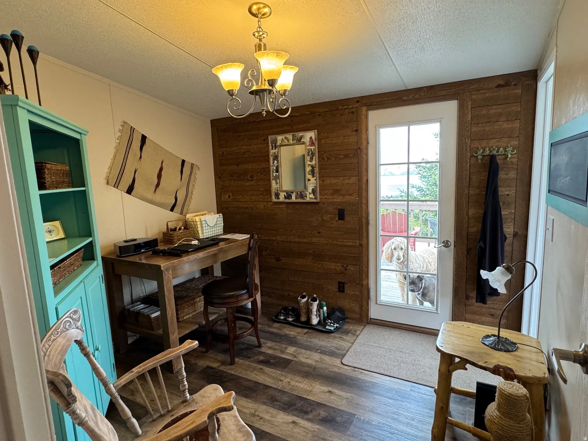 Office/bedroom space with wood walls, and LVT flooring