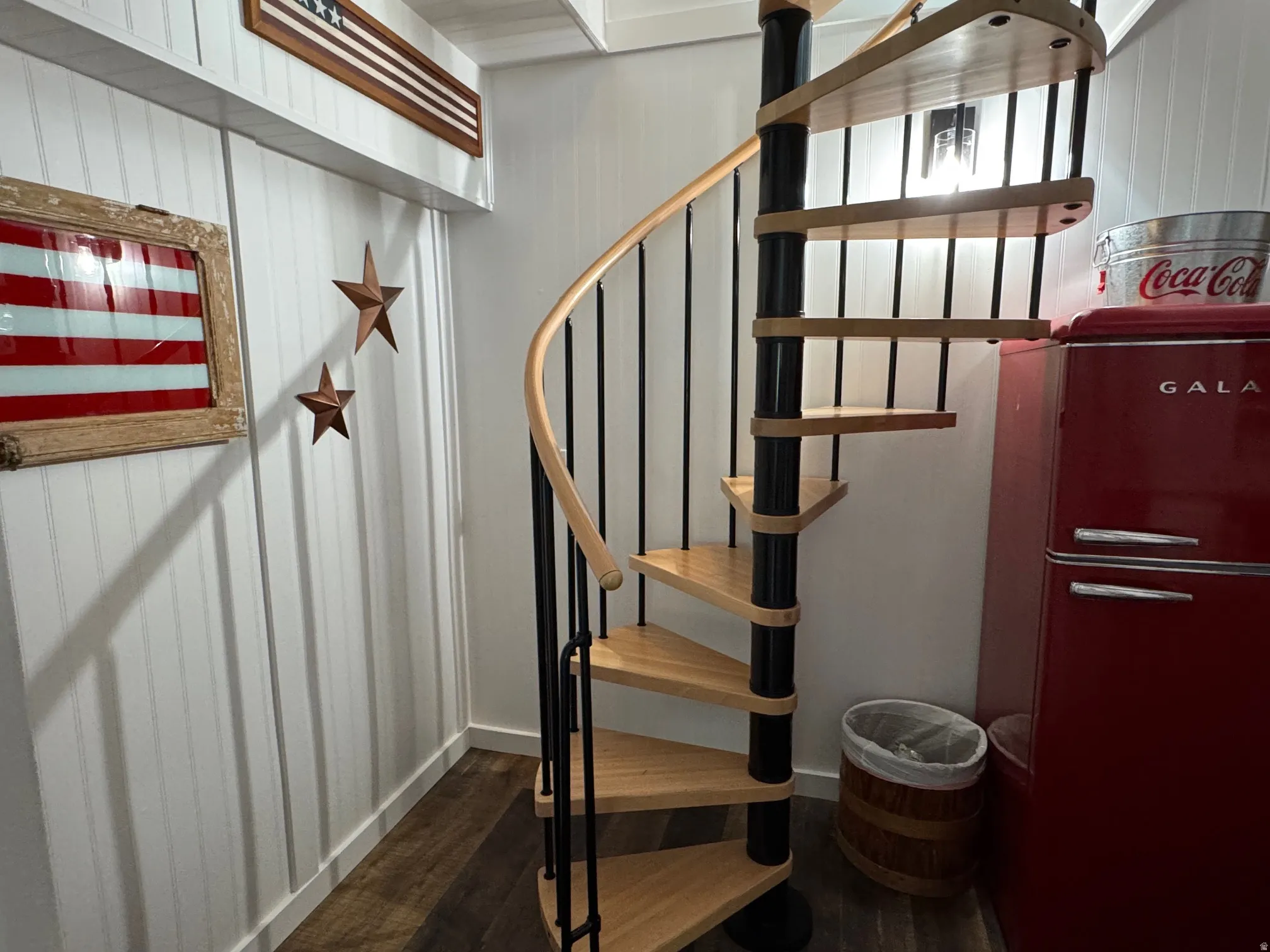 Stairs featuring wood finished floors and baseboards