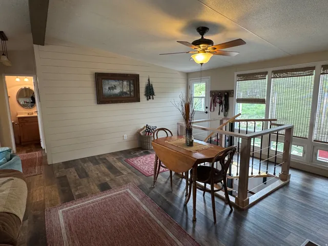 Living room area with shiplap walls and LVT flooring
