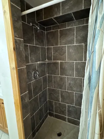 Full bath with a shower stall