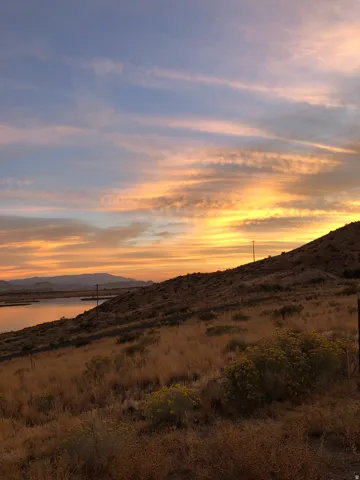 View of mountain backdrop featuring a nearby body of water