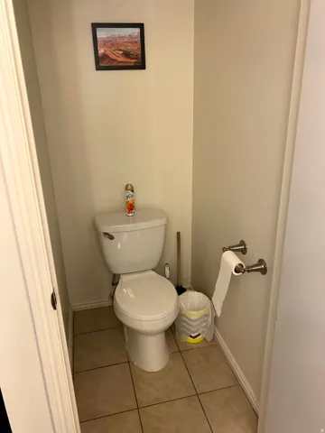 Bathroom featuring toilet and light tile patterned floors