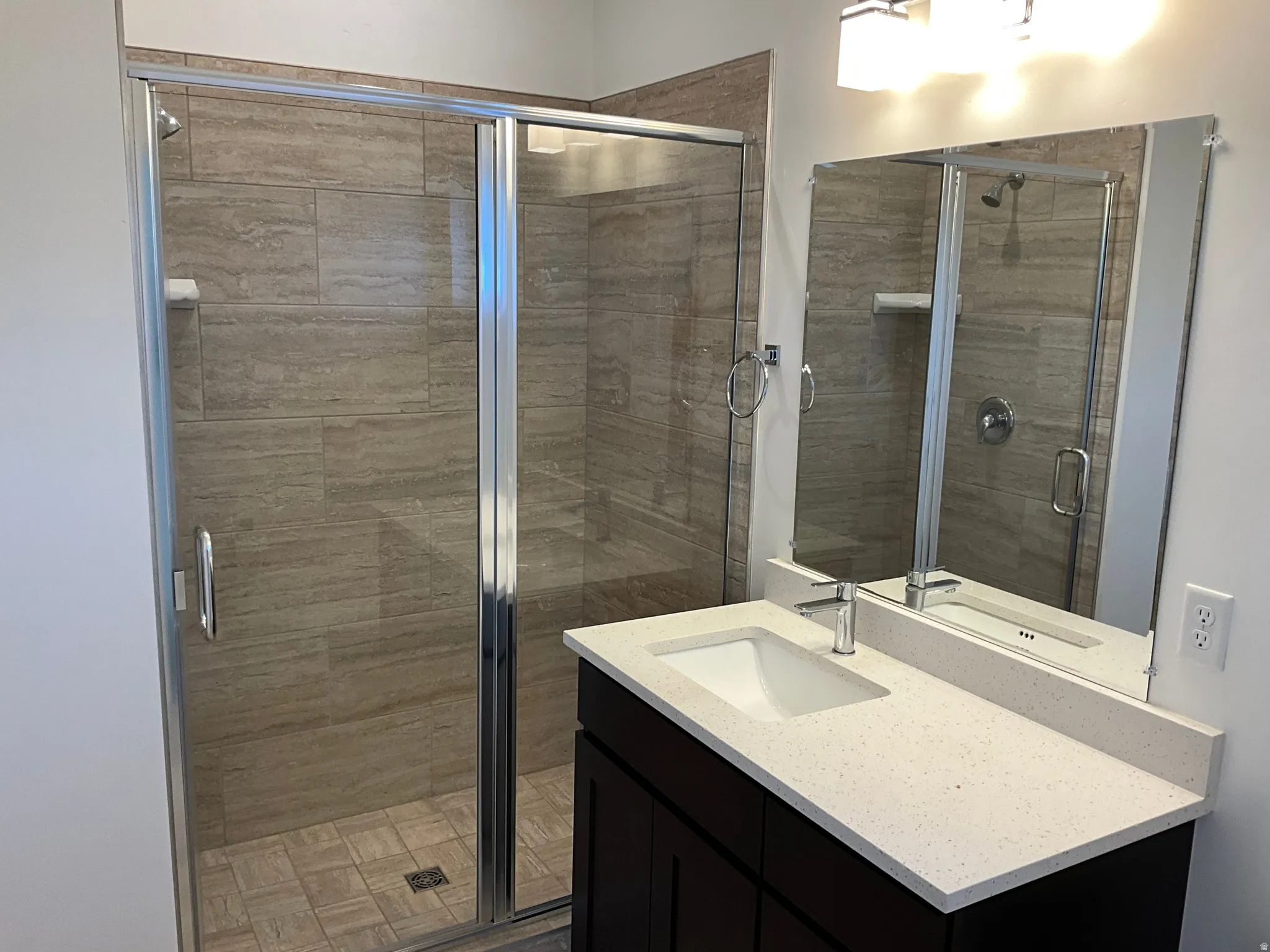 Bathroom with a shower stall and vanity