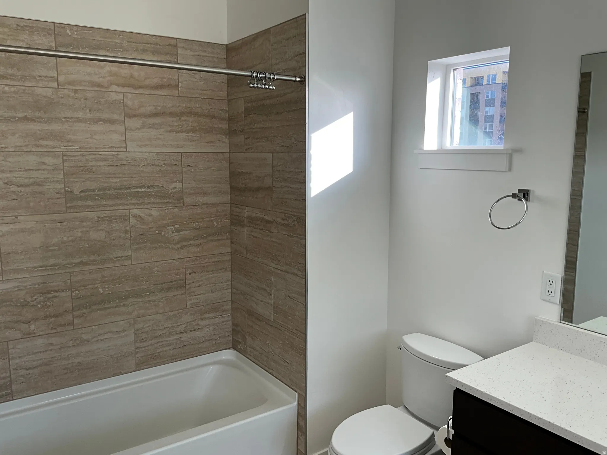 Bathroom featuring vanity and shower / washtub combination