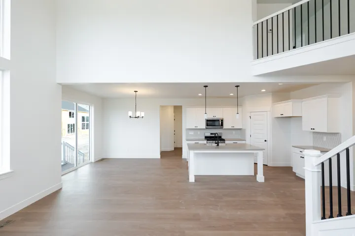 Open concept living area featuring wood-finish flooring