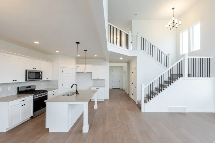 Spacious open-concept interior featuring light wood-finish flooring