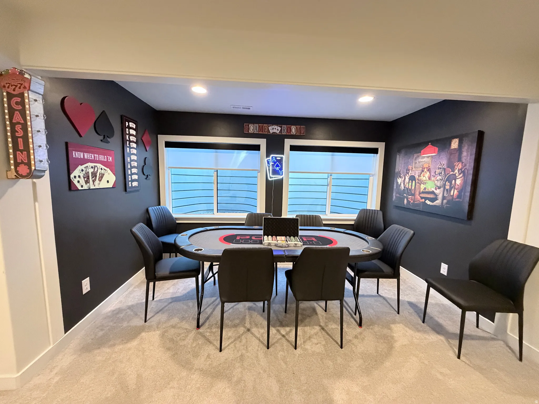 Game area that includes poker table, fun decor and game set