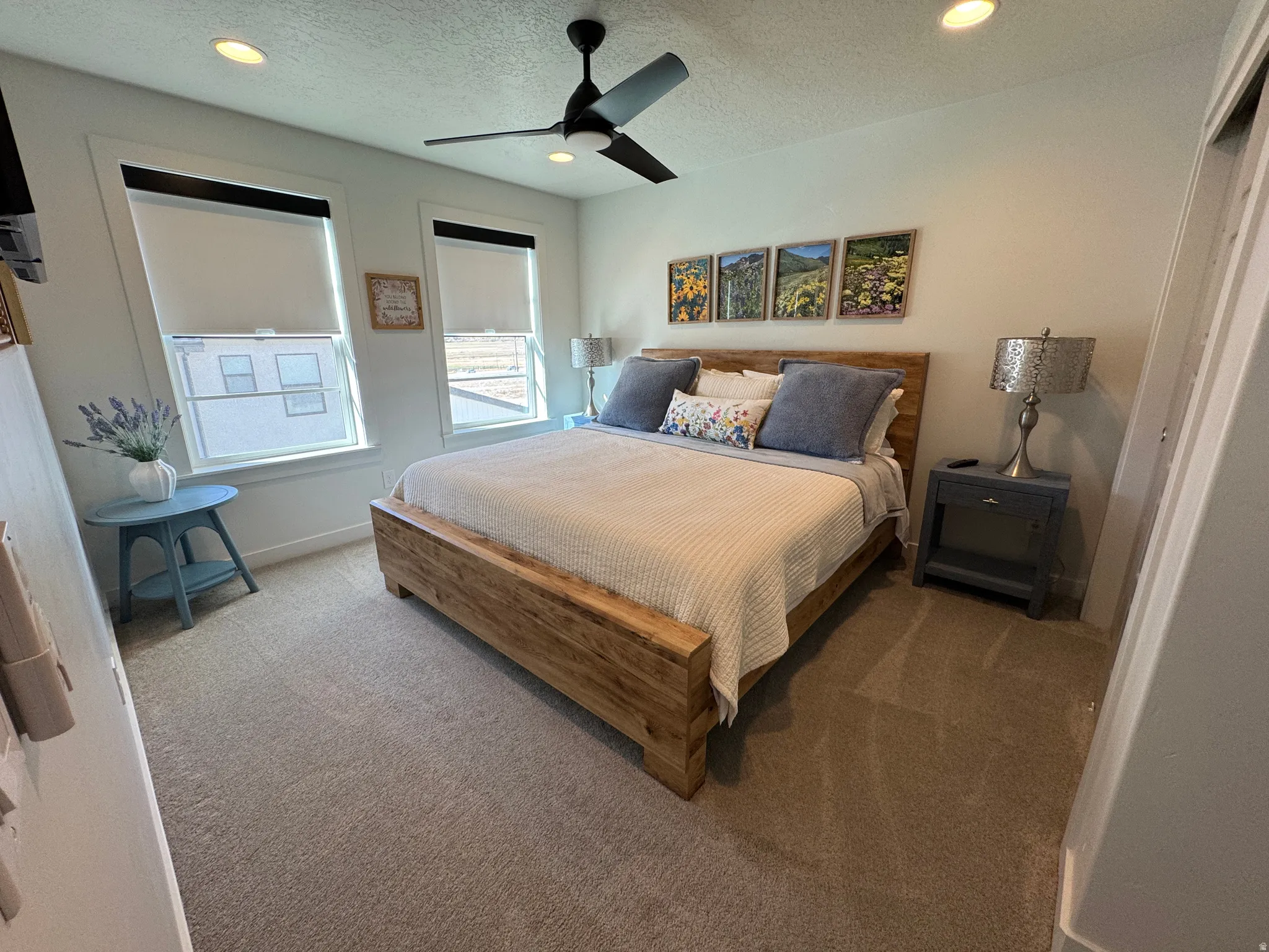 Carpeted bedroom featuring recessed lighting, a ceiling fan, king bedroom furniture, bedding and decor
