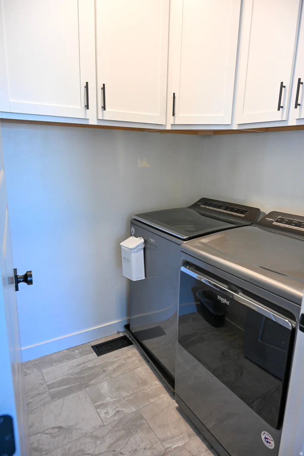 Laundry area featuring cabinet space and washer and dryer