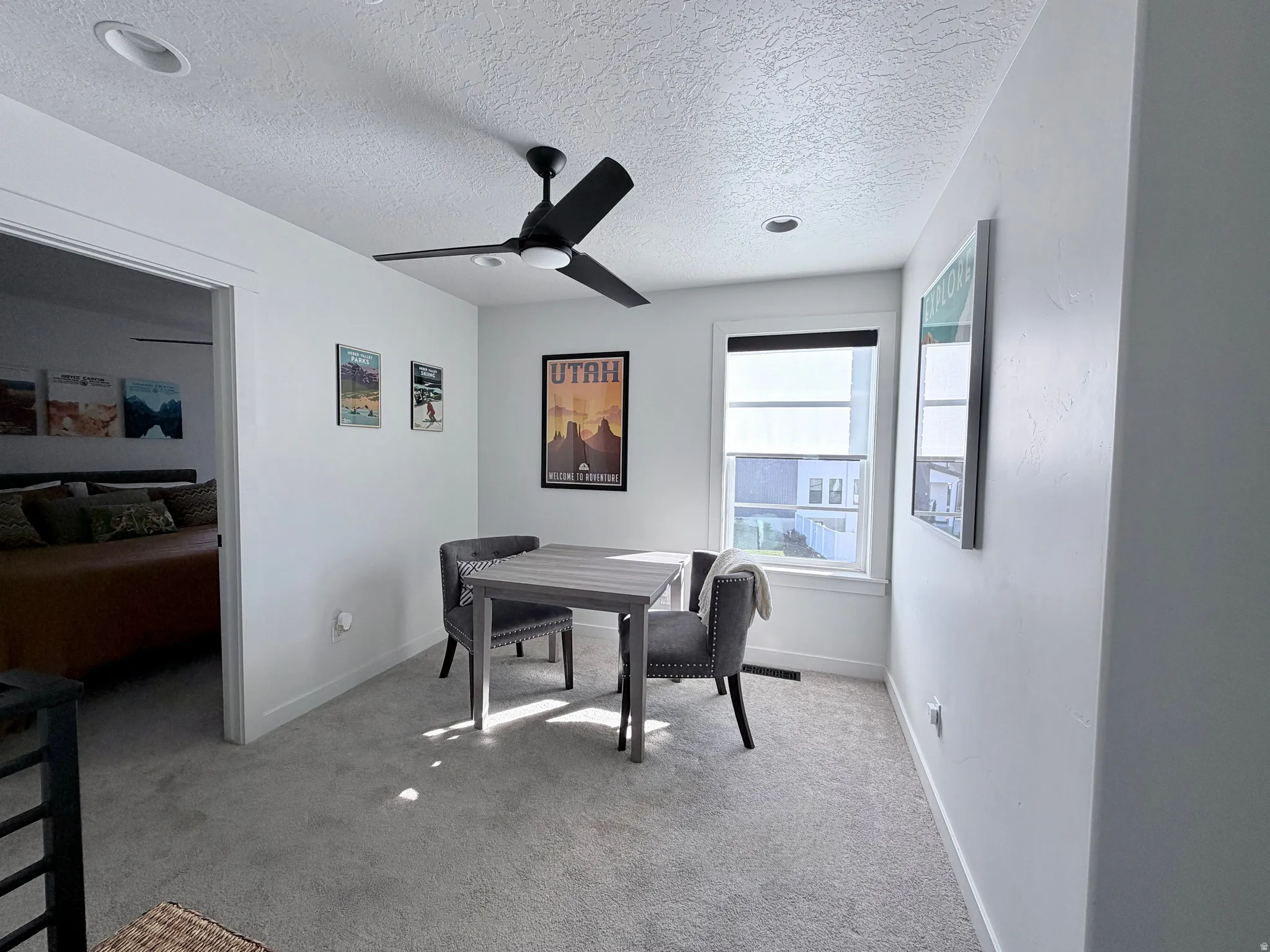 Loft area with ceiling fan, table and chairs for doing homework, puzzles or can be used as an office