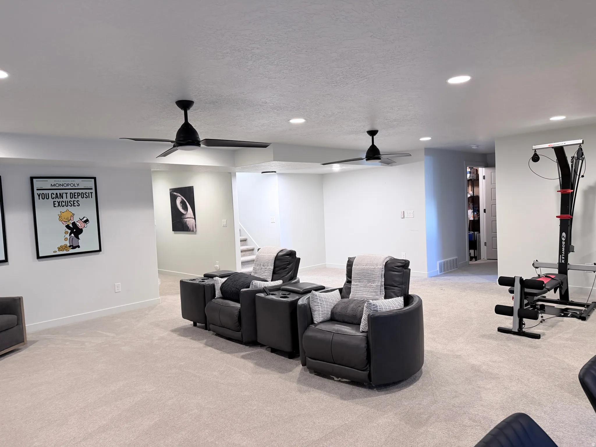 Home theater room featuring light carpet, recessed lighting, ceiling fan