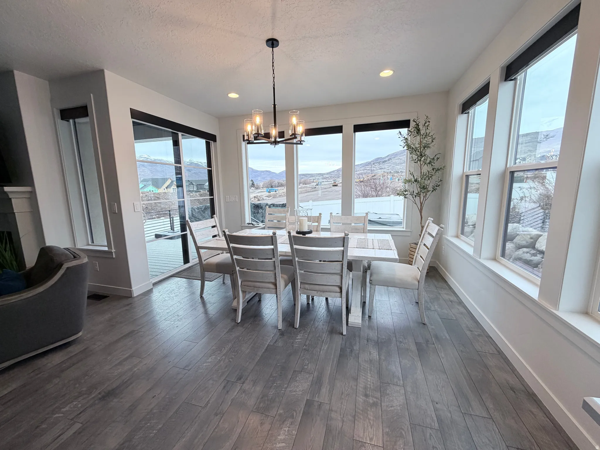 Dining room featuring a mountain view, a chandelier, natural light, dining table and chairs included