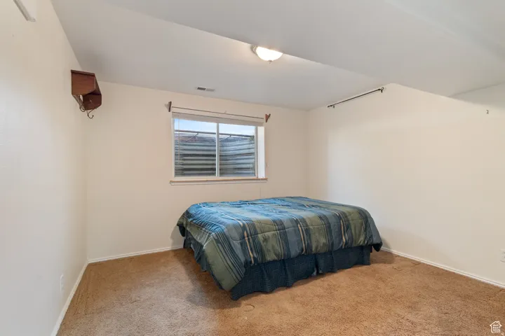 Carpeted bedroom with baseboards