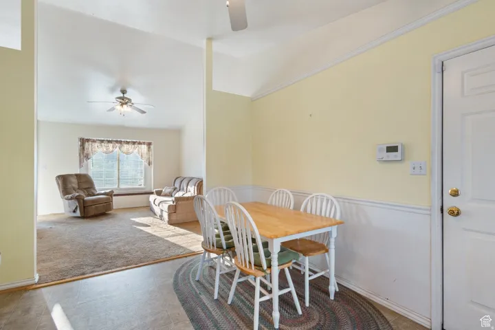 Dining room with a ceiling fan and vaulted ceiling