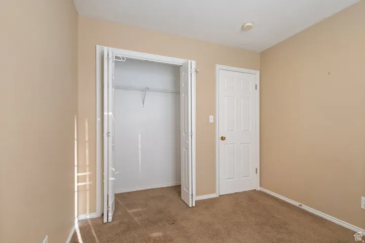 Unfurnished bedroom with carpet floors and a closet