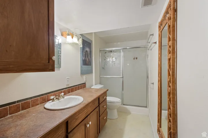 Bathroom with vanity and a stall shower
