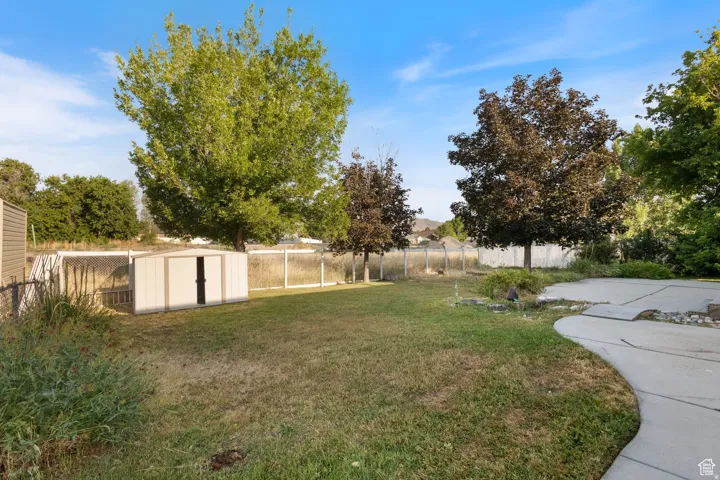 Fenced backyard with a storage unit