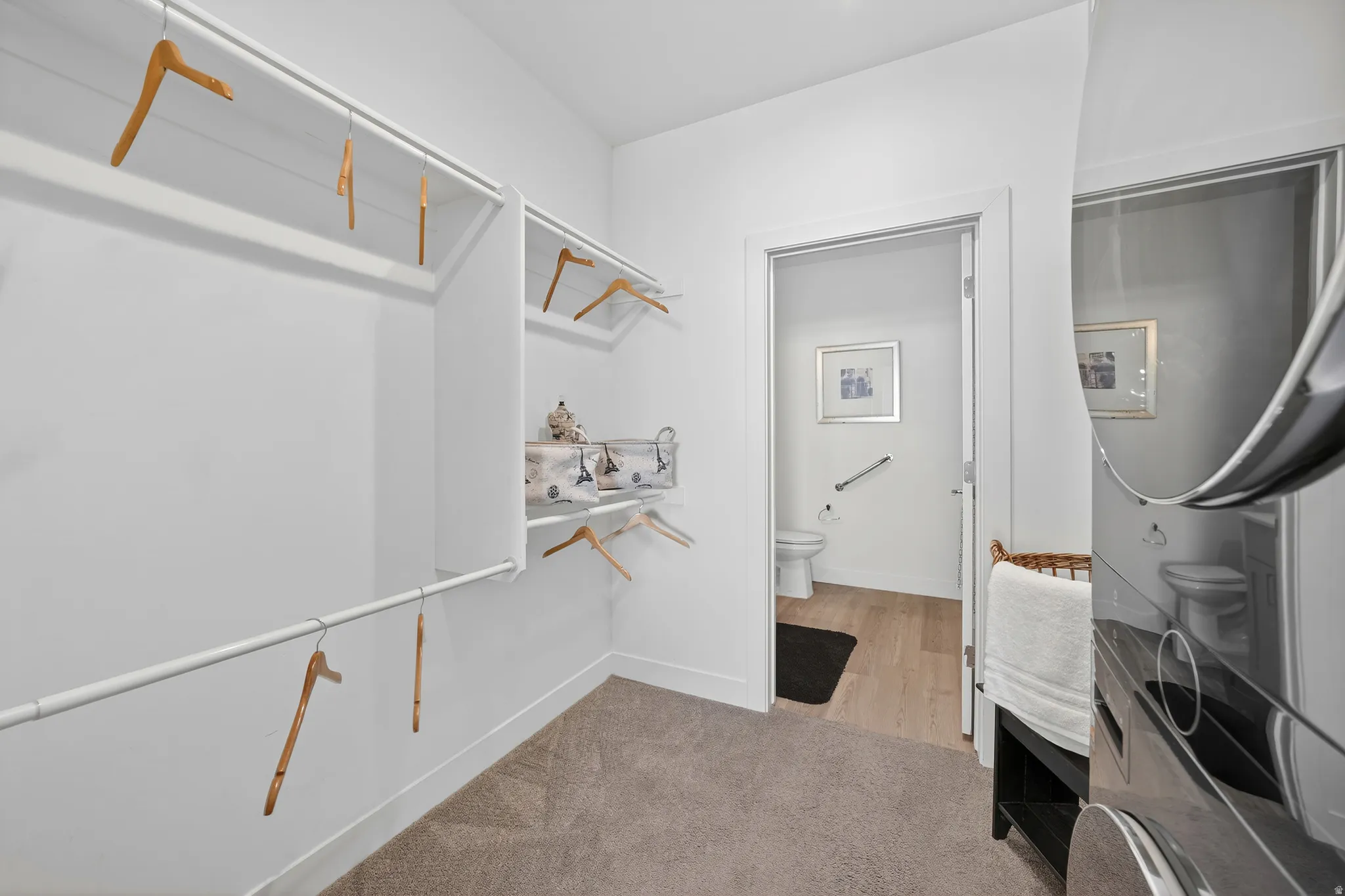 Walk in closet featuring light carpet
