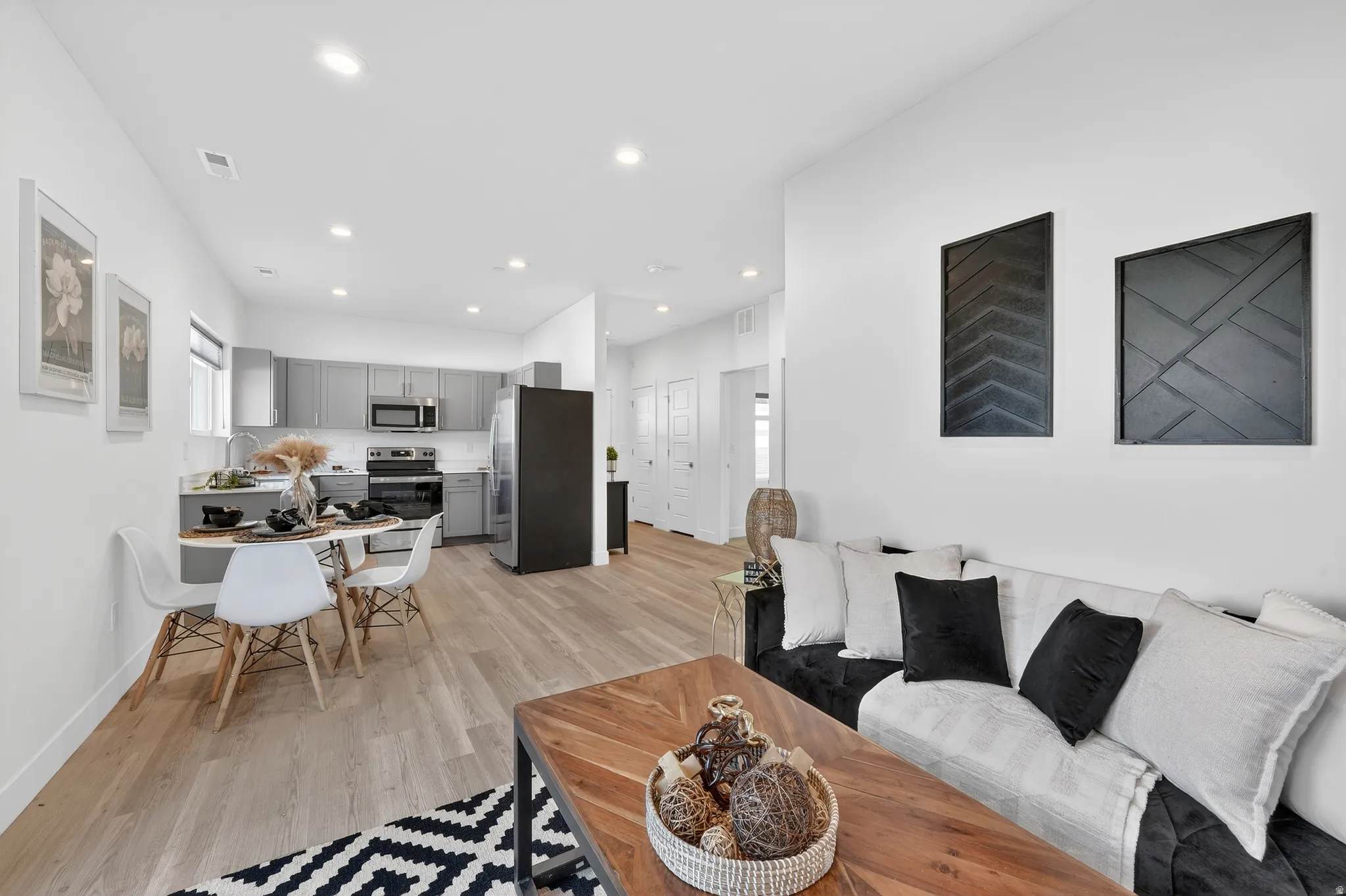 Living area featuring light wood-style floors and recessed lighting