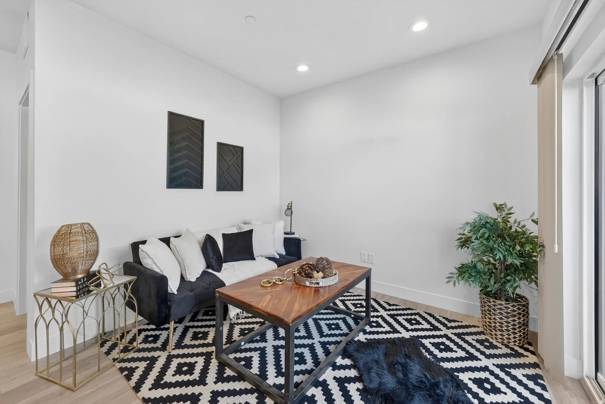 Living room featuring light wood finished floors and recessed lighting