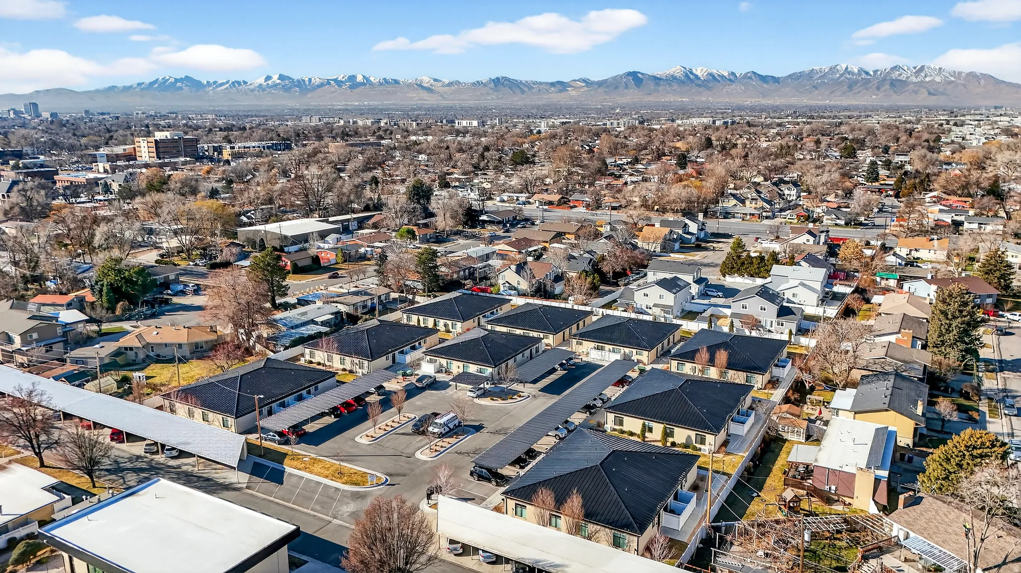 Aerial overview of property's location with a mountain backdrop and nearby suburban area