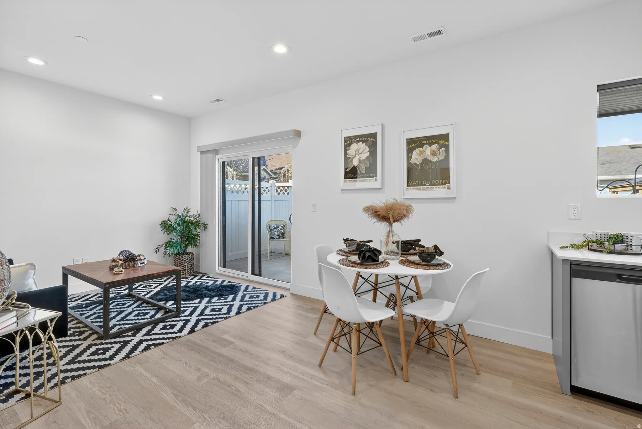 Dining space with light wood-style flooring and recessed lighting