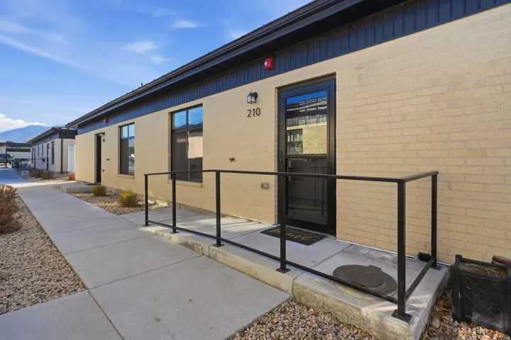 View of exterior entry with brick siding