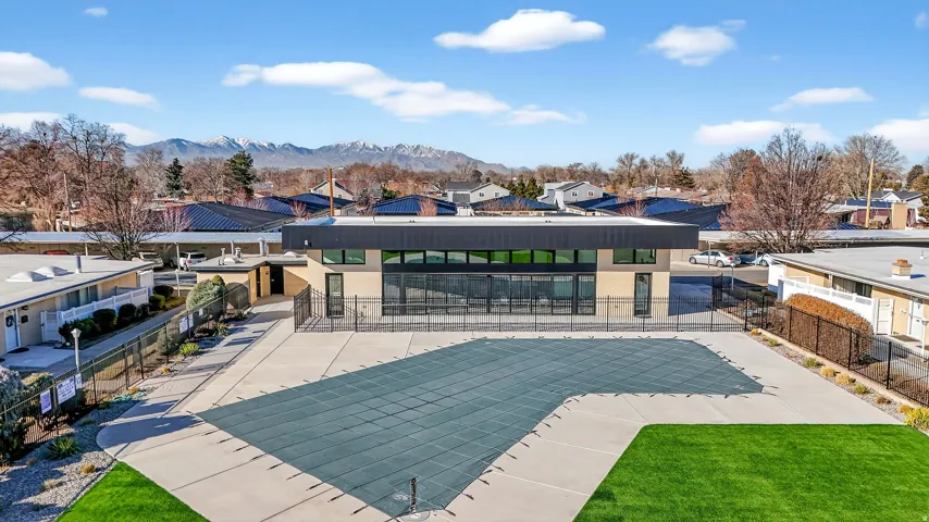 View of swimming pool with a residential view, a patio area, and a mountain view