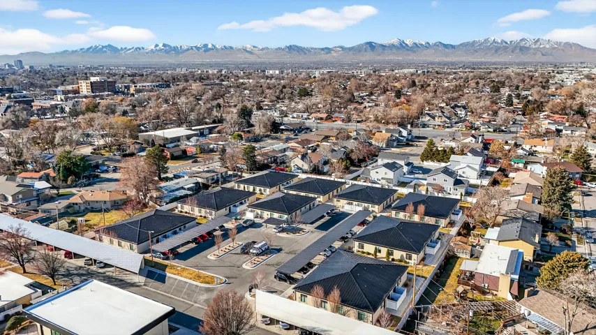 Aerial overview of property's location with a mountain backdrop and nearby suburban area
