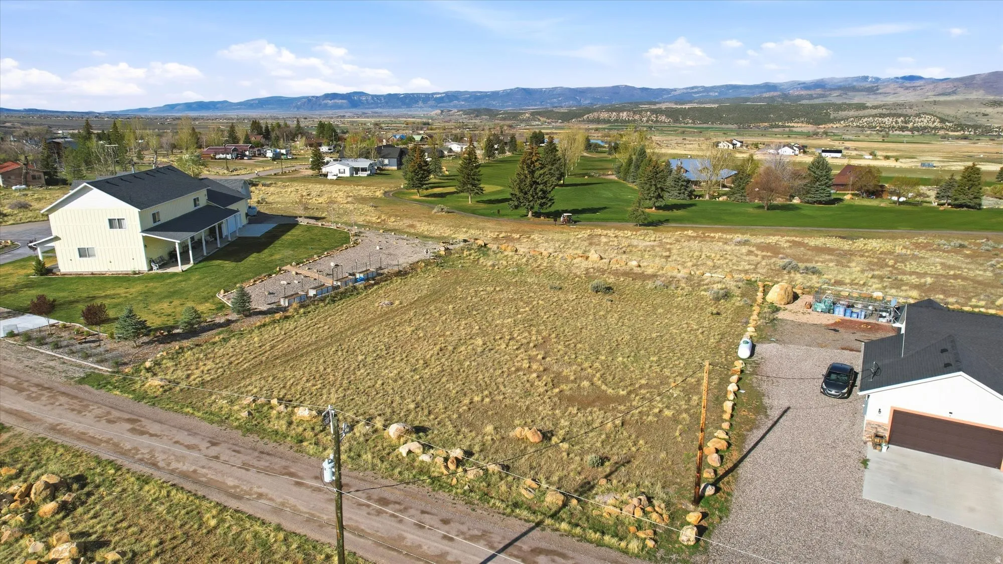 Expansive open lot featuring natural landscaping and mountain scenery