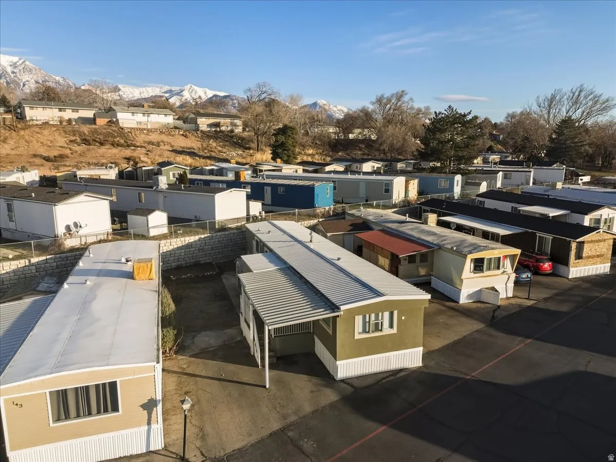 Aerial view of residential area featuring a mountainous background
