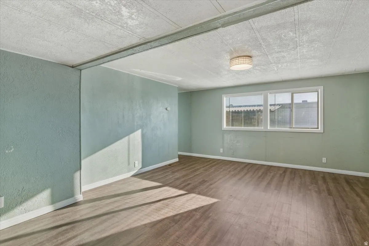 A sprawling, light-filled living area designed for modern multi-tasking. With enough square footage to house a full entertainment center and a dedicated home office nook, this is the true heart of the home.