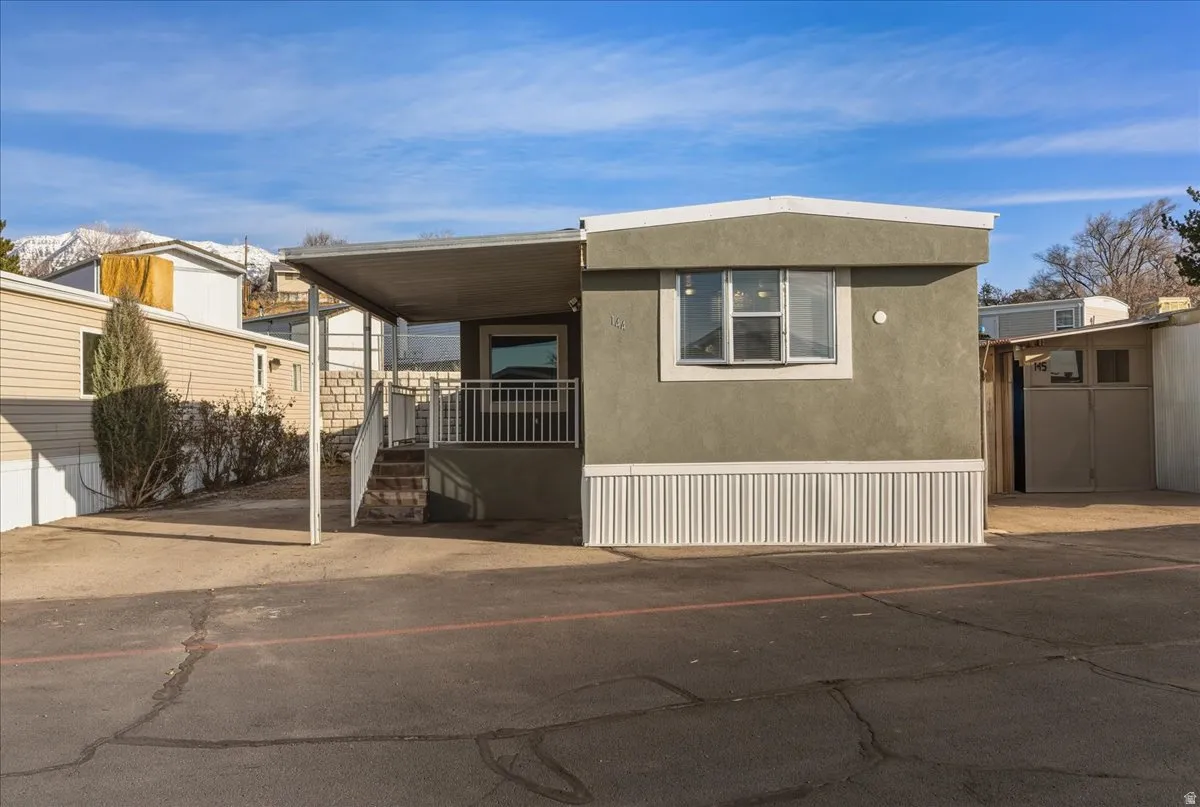 Welcome home! This charming, updated 2-bedroom residence features a tiled, covered front porch—perfect for relaxing—and a pride-of-ownership exterior in Village Green Mobile Home Park.