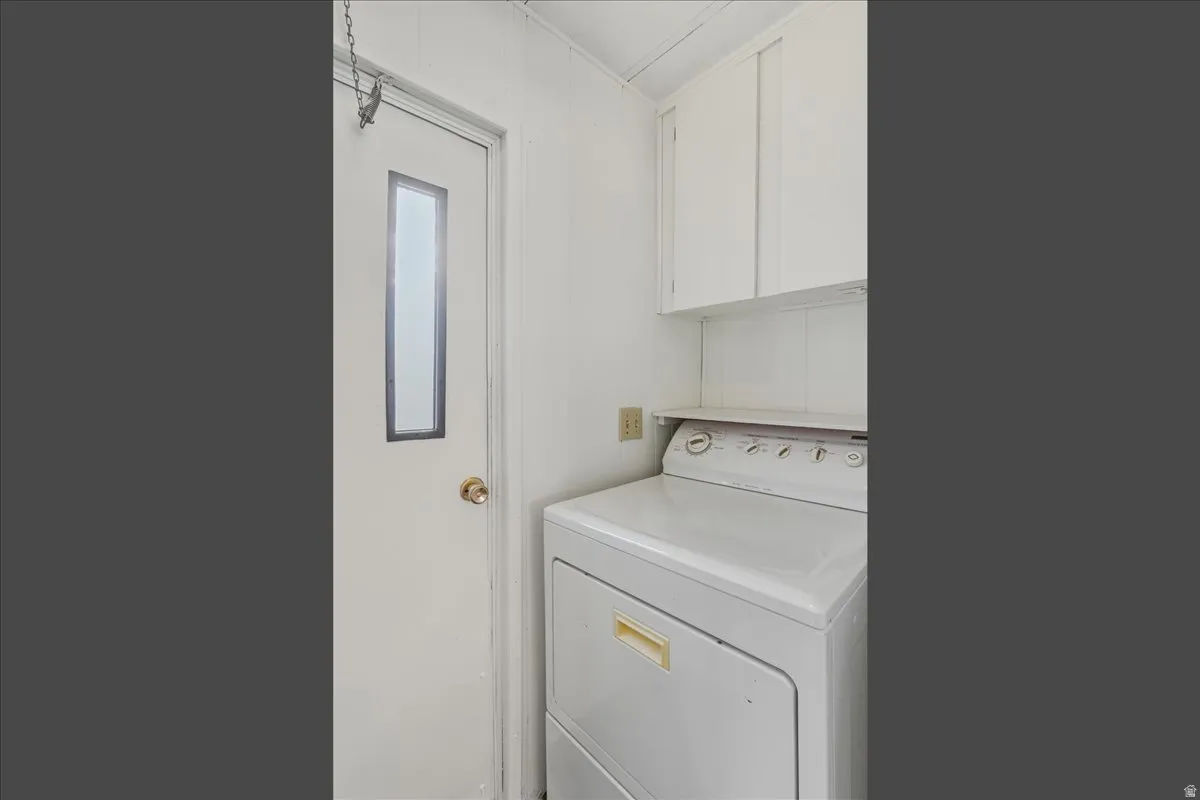 Laundry room featuring included washer / dryer and cabinet space