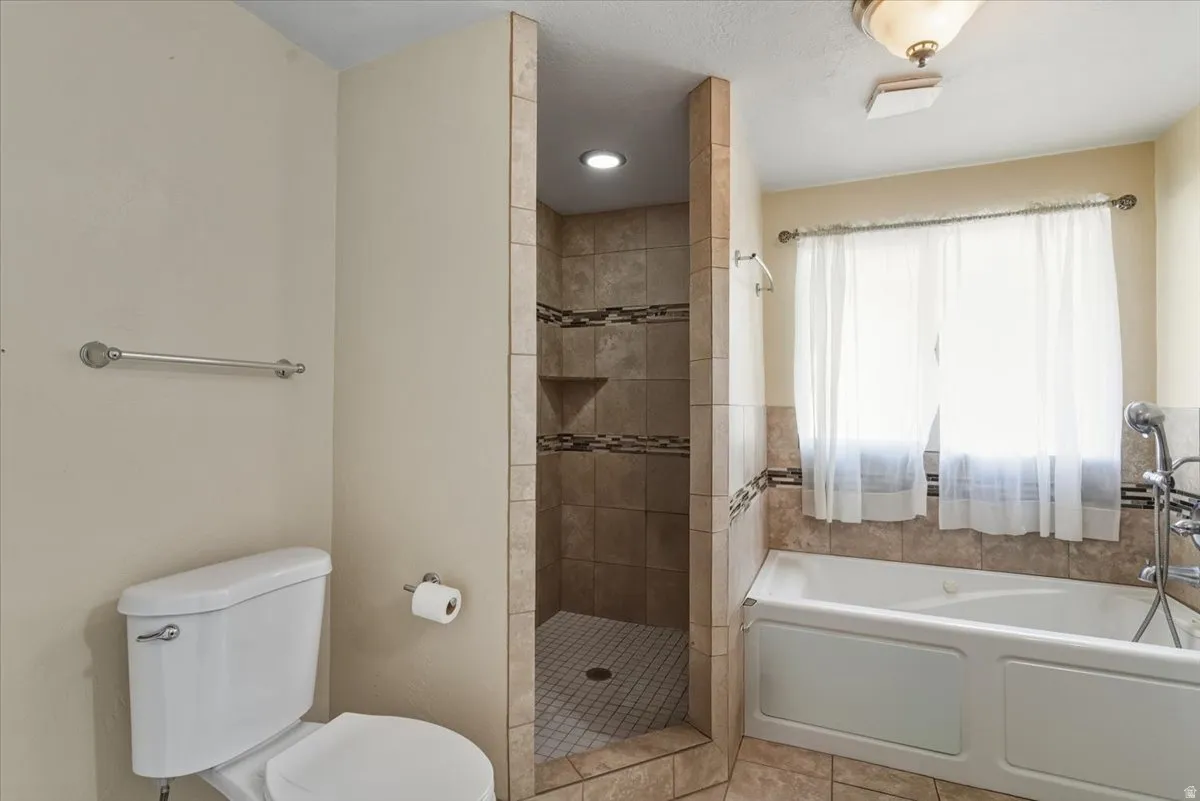 Full bath with a garden tub and a tile shower