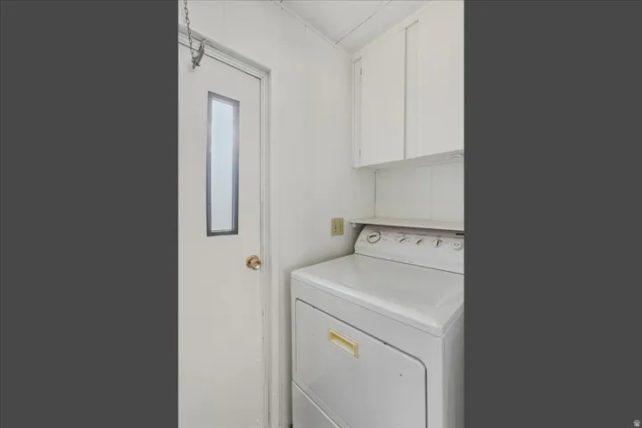 Laundry room featuring included washer / dryer and cabinet space