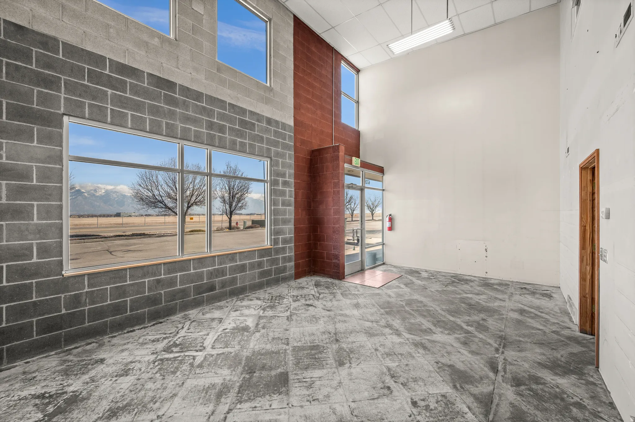 Unfurnished room with a high ceiling and a mountain view